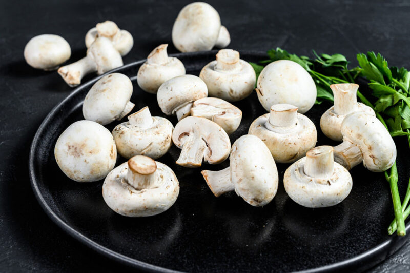 Why is it important to integrate picking lorries with shelving systems in mushroom farms